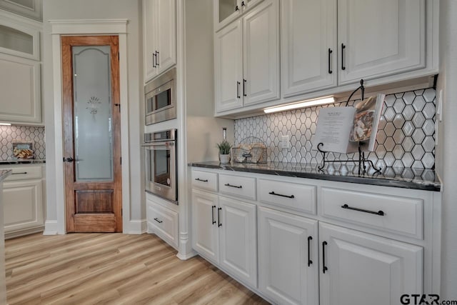 93 S Ryder Cup, Hideaway, TX 75771 - kitchen featuring decorative backsplash, white cabinetry, glass insert cabinets, and stainless steel appliances