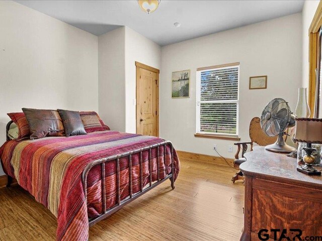 bedroom with hardwood / wood-style flooring