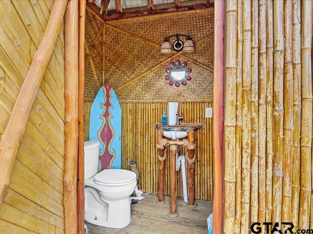 bathroom with hardwood / wood-style floors and toilet