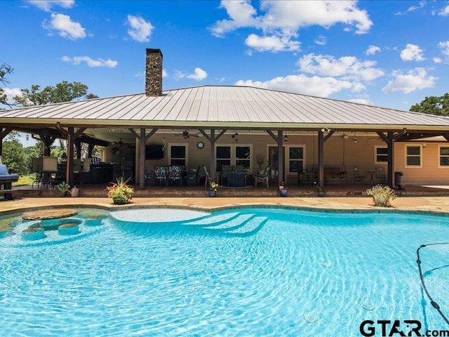 view of pool with a patio and ceiling fan