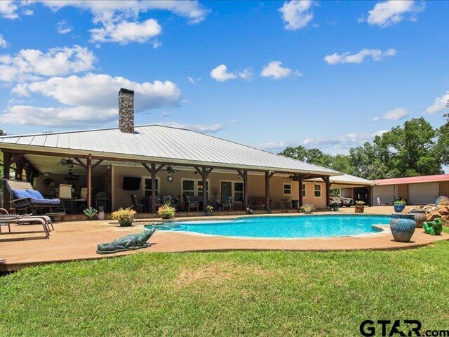 view of swimming pool featuring a patio and a lawn