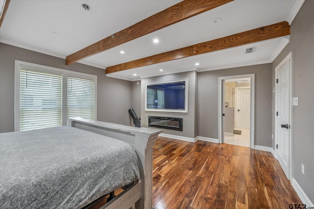 bedroom featuring baseboards, visible vents, dark wood-style floors, and beam ceiling