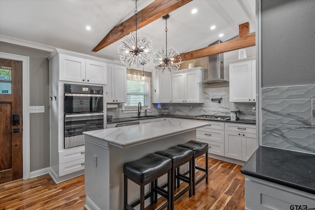 kitchen with lofted ceiling with beams, a notable chandelier, dark wood-type flooring, and a sink