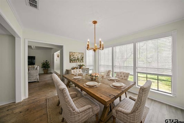 2110 Macbeth Ct, Tyler, TX 75703 - dining room with a notable chandelier, dark wood-style floors, and visible vents