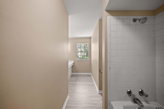 2110 Macbeth Ct, Tyler, TX 75703 - bathroom with baseboards, tub / shower combination, and wood finished floors