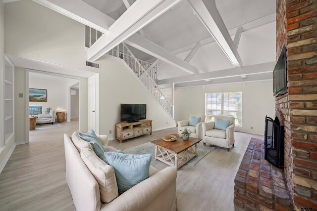 2110 Macbeth Ct, Tyler, TX 75703 - living room with visible vents, stairs, a brick fireplace, baseboards, and high vaulted ceiling