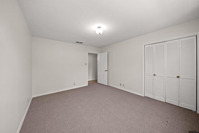 2110 Macbeth Ct, Tyler, TX 75703 - unfurnished bedroom featuring baseboards, carpet flooring, visible vents, and a closet