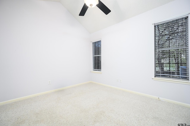 carpeted spare room featuring lofted ceiling and ceiling fan