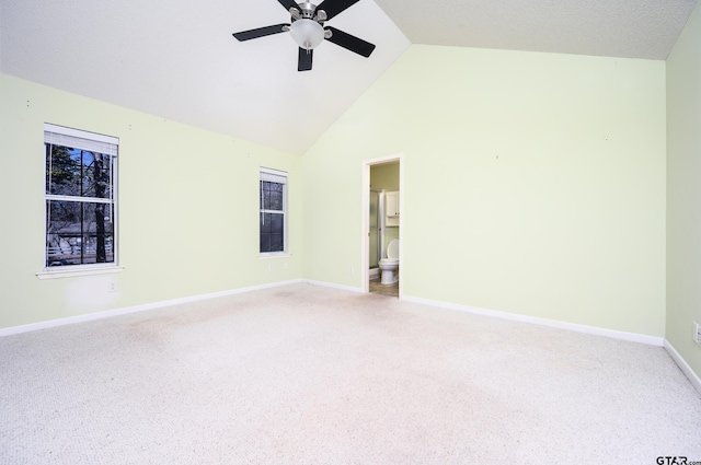 carpeted spare room with high vaulted ceiling and ceiling fan