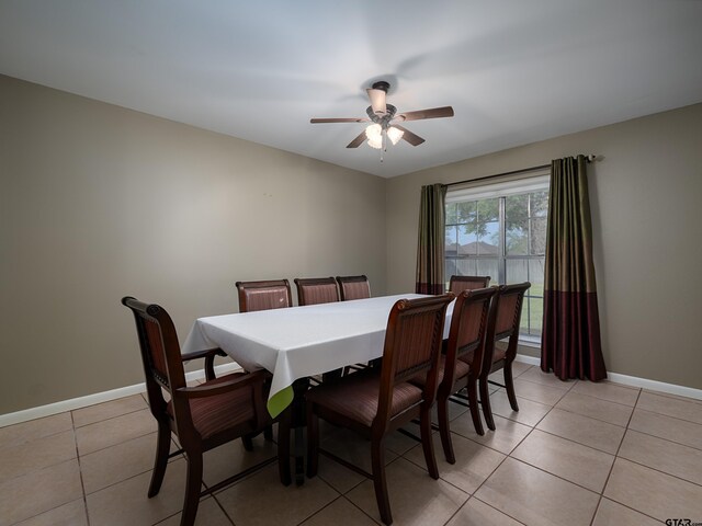 dining space with light tile patterned floors, ceiling fan, and baseboards
