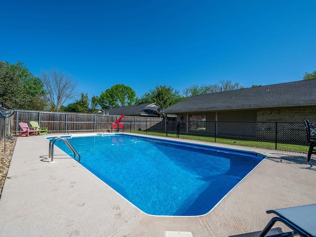 view of swimming pool featuring a fenced in pool, a patio, and a fenced backyard