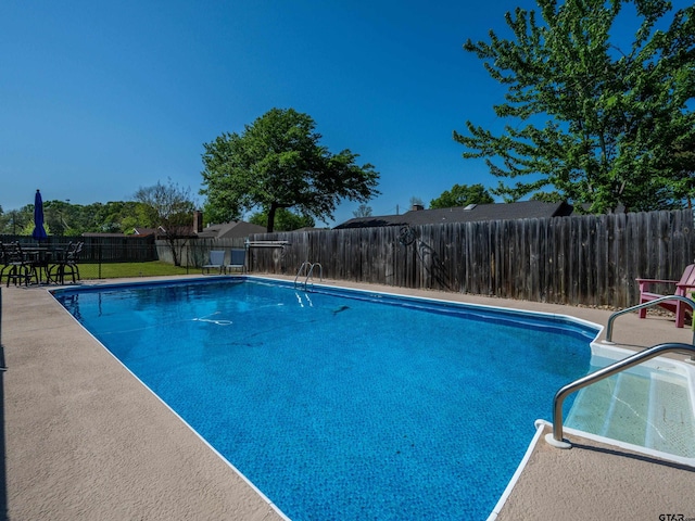 view of swimming pool featuring a fenced backyard, a fenced in pool, and a patio area