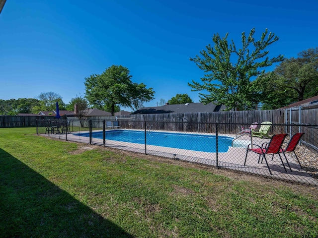 view of pool with a fenced in pool, a fenced backyard, and a lawn