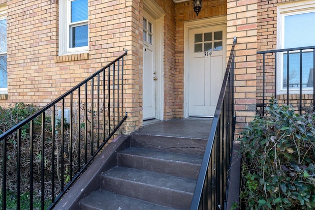 doorway to property with brick siding