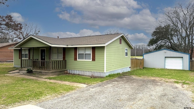 view of front facade featuring an outbuilding, a garage, and a front lawn