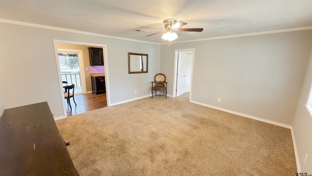 unfurnished room featuring crown molding, carpet floors, and ceiling fan