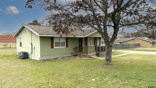 view of front of property with central AC and a front yard