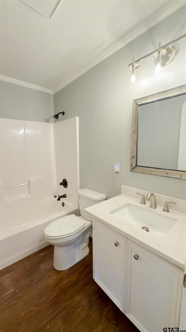 full bathroom with shower / washtub combination, wood-type flooring, vanity, toilet, and crown molding