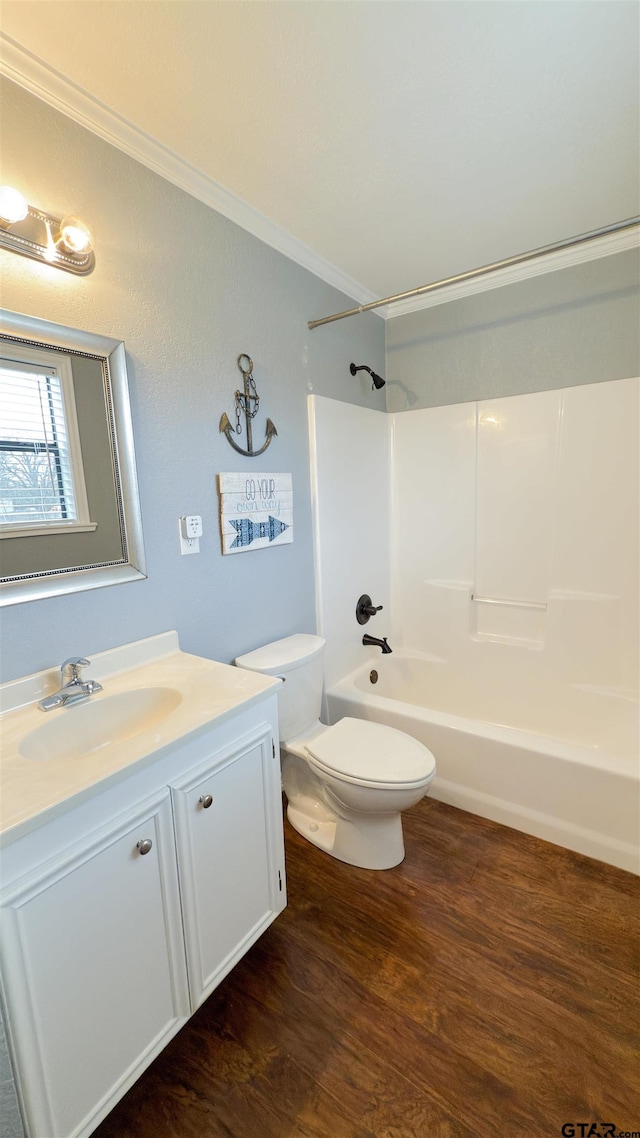 full bathroom with toilet, wood-type flooring, ornamental molding, vanity, and shower / bath combination