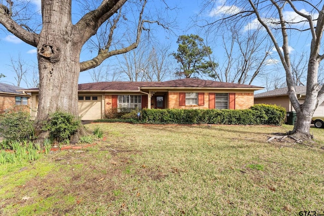 ranch-style home with a garage and a front yard