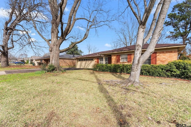 single story home featuring a garage and a front lawn