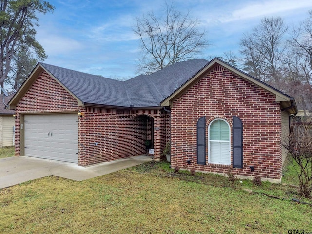 single story home with brick siding, a shingled roof, a front yard, a garage, and driveway