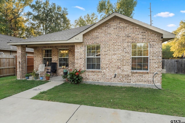 view of front facade featuring a front lawn and a patio area