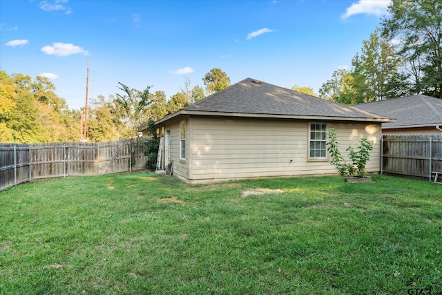 rear view of property with a lawn