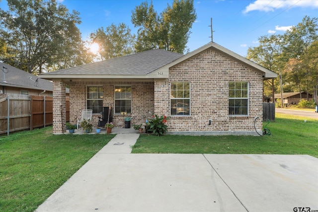 back of property featuring a yard and covered porch