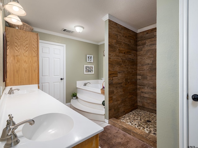 bathroom featuring vanity, a textured ceiling, ornamental molding, and separate shower and tub