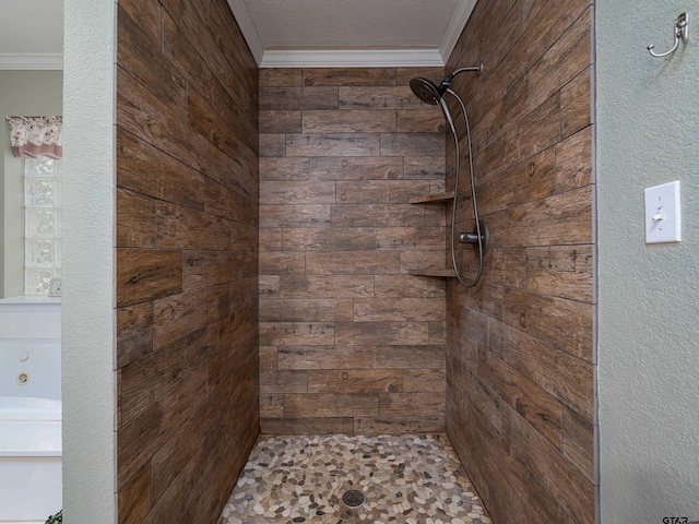 bathroom with tiled shower and a textured ceiling