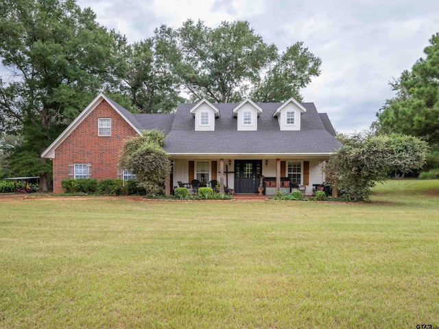 new england style home with a porch and a front lawn