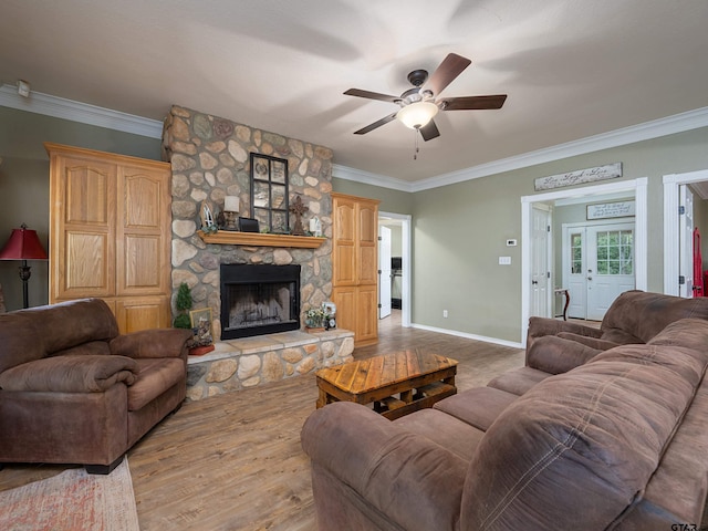 living room with a fireplace, hardwood / wood-style flooring, ceiling fan, and crown molding