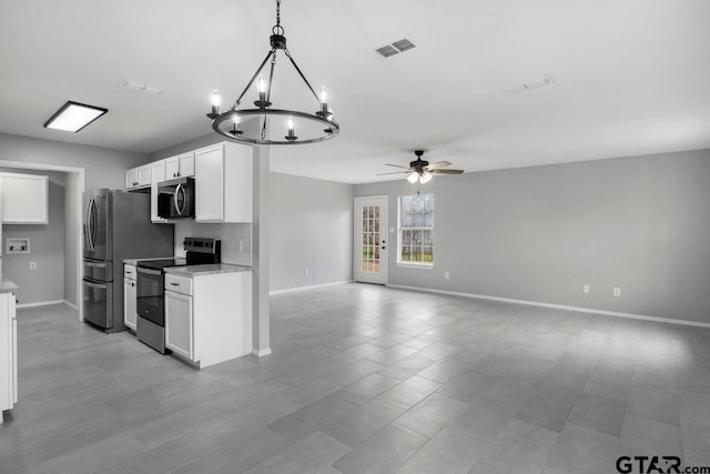 kitchen with ceiling fan with notable chandelier, visible vents, baseboards, white cabinetry, and appliances with stainless steel finishes