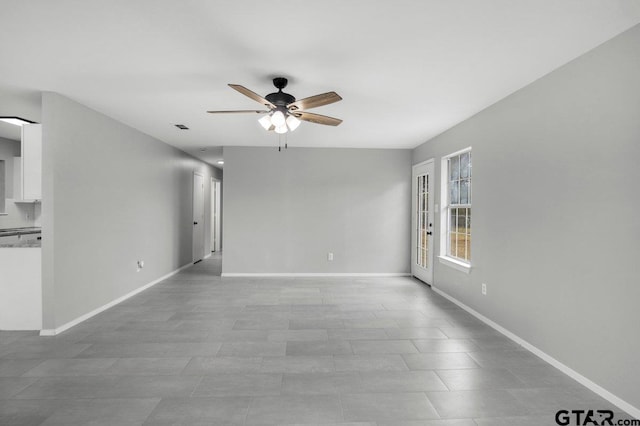 unfurnished room with ceiling fan, visible vents, and baseboards