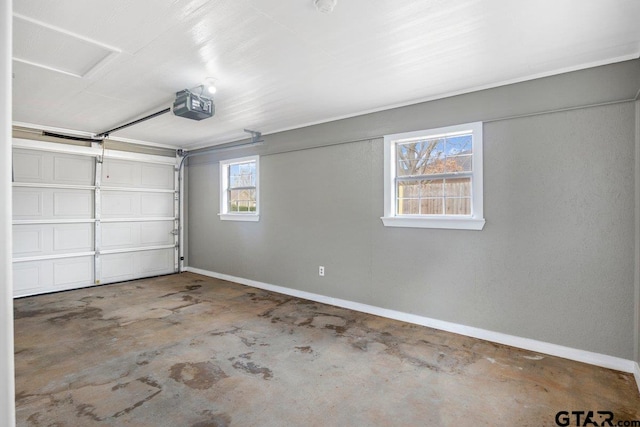 garage with baseboards and a garage door opener