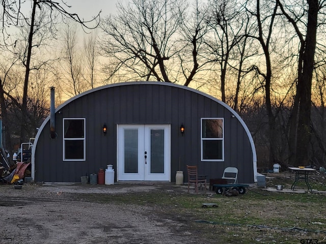 outdoor structure at dusk with french doors