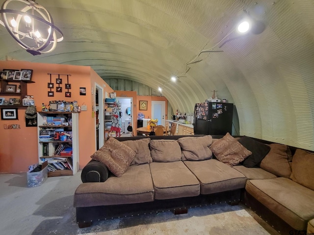 living room with lofted ceiling and concrete floors