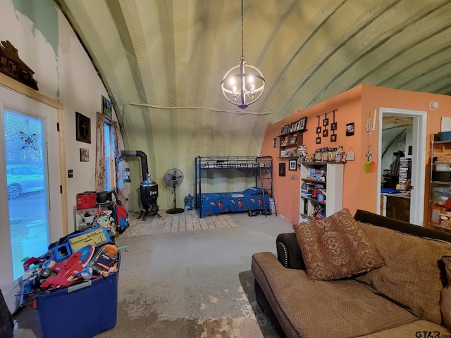 living room featuring concrete floors, lofted ceiling, and an inviting chandelier