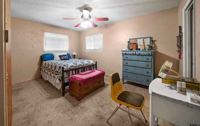 bedroom with a textured ceiling, carpet floors, and ceiling fan