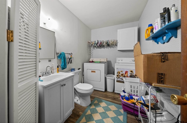 bathroom featuring toilet, washer and dryer, vanity, and hardwood / wood-style floors