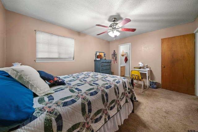 carpeted bedroom featuring a textured ceiling and ceiling fan