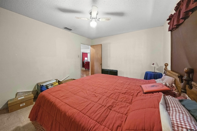 bedroom featuring a textured ceiling and ceiling fan