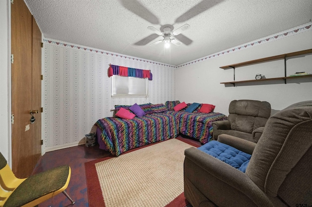 bedroom with ceiling fan and a textured ceiling