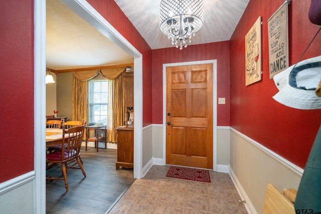 entrance foyer with baseboards and a notable chandelier