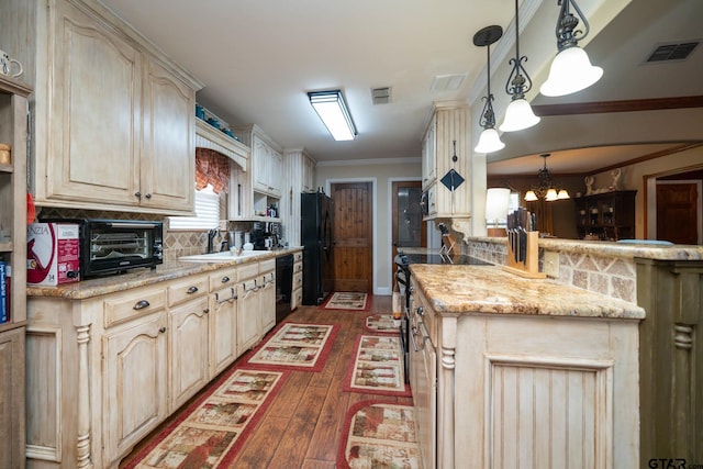 kitchen with dark wood finished floors, backsplash, visible vents, a sink, and black appliances