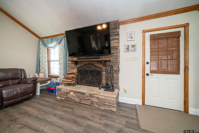 living room with a stone fireplace, crown molding, wood finished floors, and baseboards