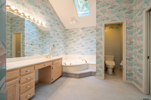 bathroom featuring toilet, vanity, a bath, and a skylight