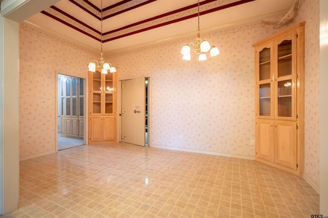 unfurnished dining area with ornamental molding and an inviting chandelier