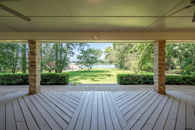 wooden terrace with a lawn